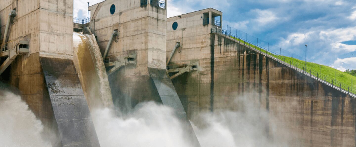 A substantial dam releasing water, representing enhanced cash flow potential via six strategies at Peter Trifelly, a Certified Business Coach